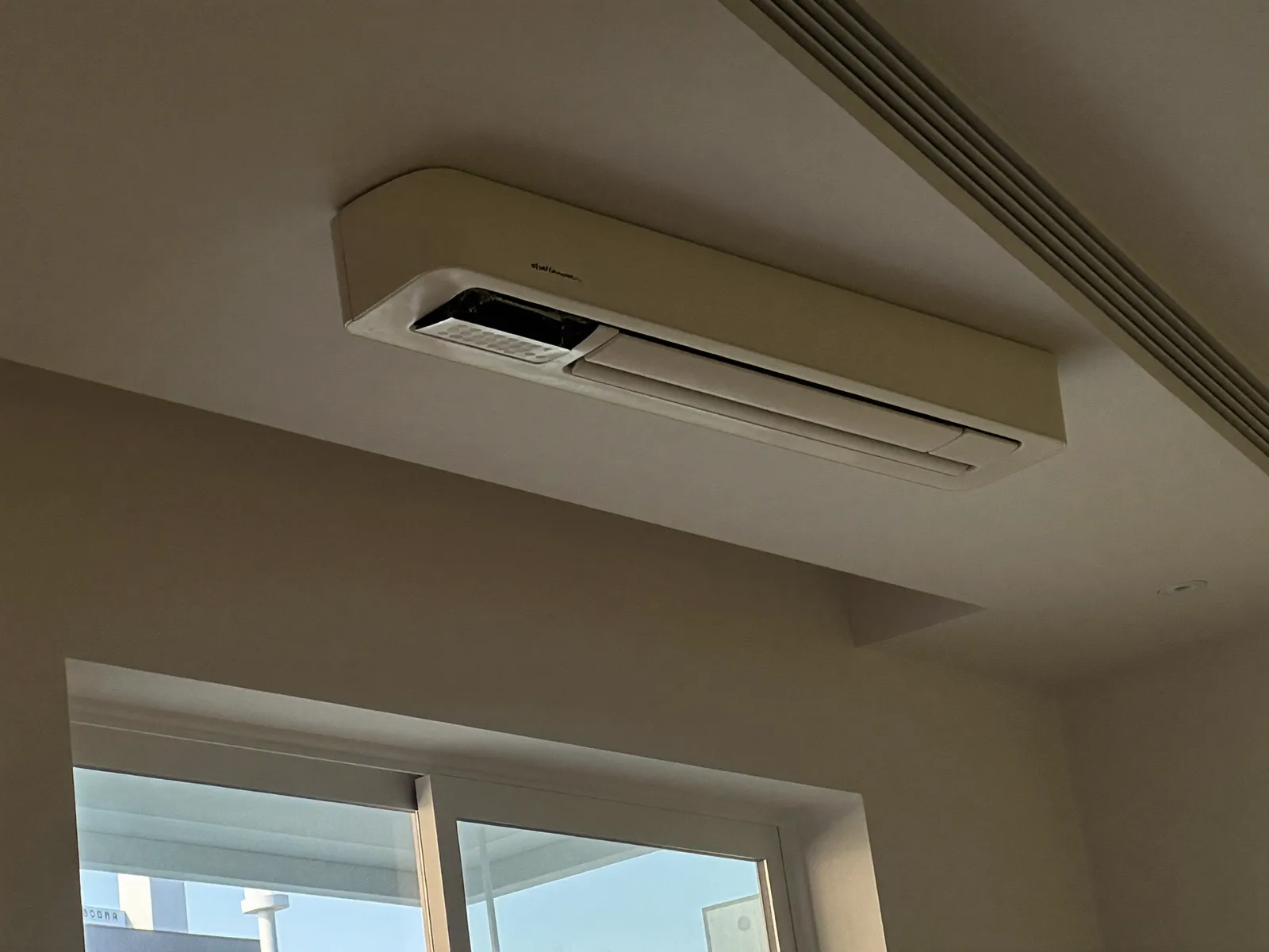 Close-up of grey dust streaks on a linear ceiling air diffuser in a Dubai apartment